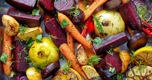 Photo of assorted roasted vegetables including shaved carrots, lemons and assorted root vegetables