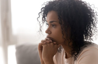 Woman contemplating the warning signs of cancer