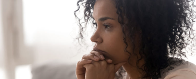 Woman contemplating the warning signs of cancer