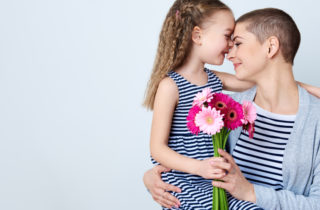 A cancer survivor hugs her child.