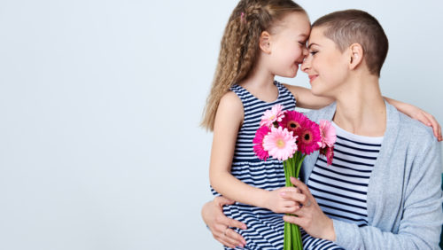 A cancer survivor hugs her child.