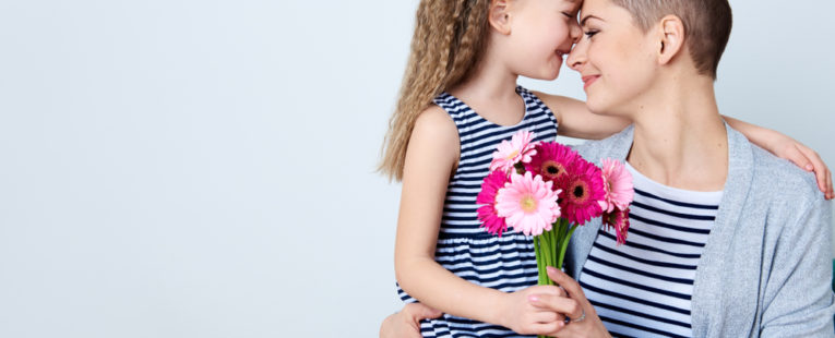 A cancer survivor hugs her child.