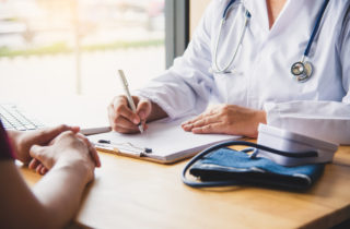 An job applicant speaks to a provider during a pre-employment physical.