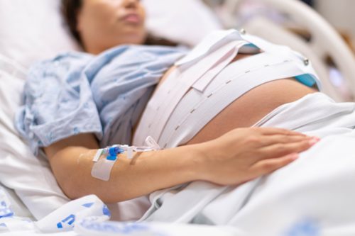 A woman in the hospital is getting induced for labor.