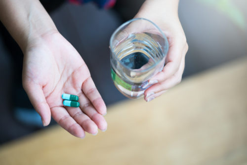hands holding magnesium supplement
