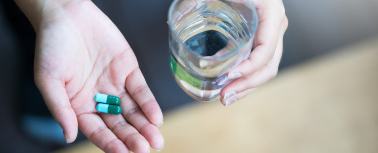 hands holding magnesium supplement