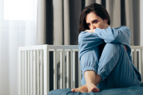 Woman dealing with postpartum depression and/or baby blues.