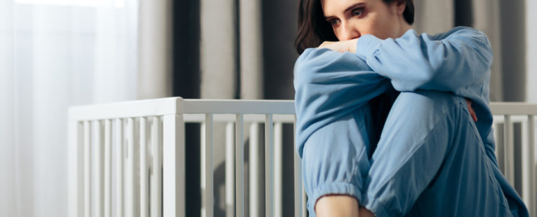 Woman dealing with postpartum depression and/or baby blues.