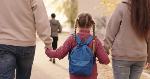 social drivers of health, mom and dad walking child to school