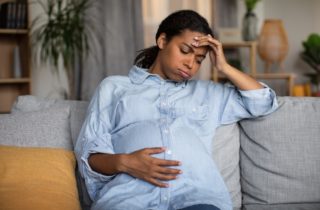 pregnant woman in labor thinking about going to hospital