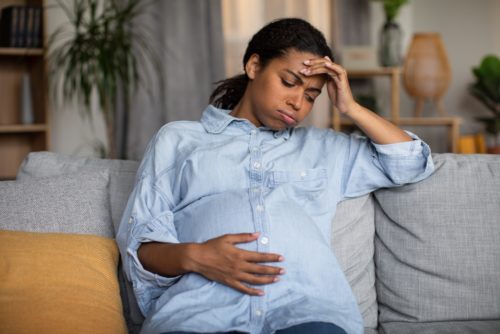 pregnant woman in labor thinking about going to hospital