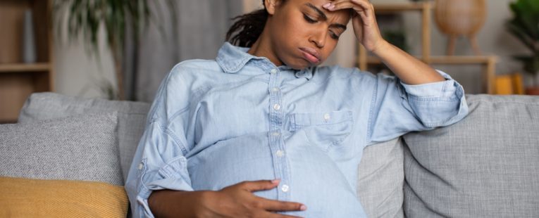 pregnant woman in labor thinking about going to hospital