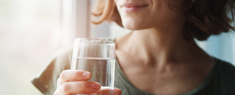 woman holding water glass, drinking water, hydration