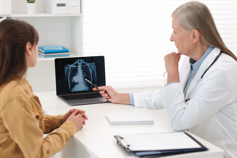 female doctor and patient review x-rays of the chest in an office