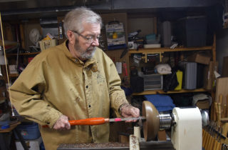 David Alfredson turning a wooden bowl on a lathe
