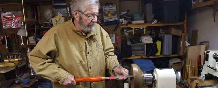 David Alfredson turning a wooden bowl on a lathe